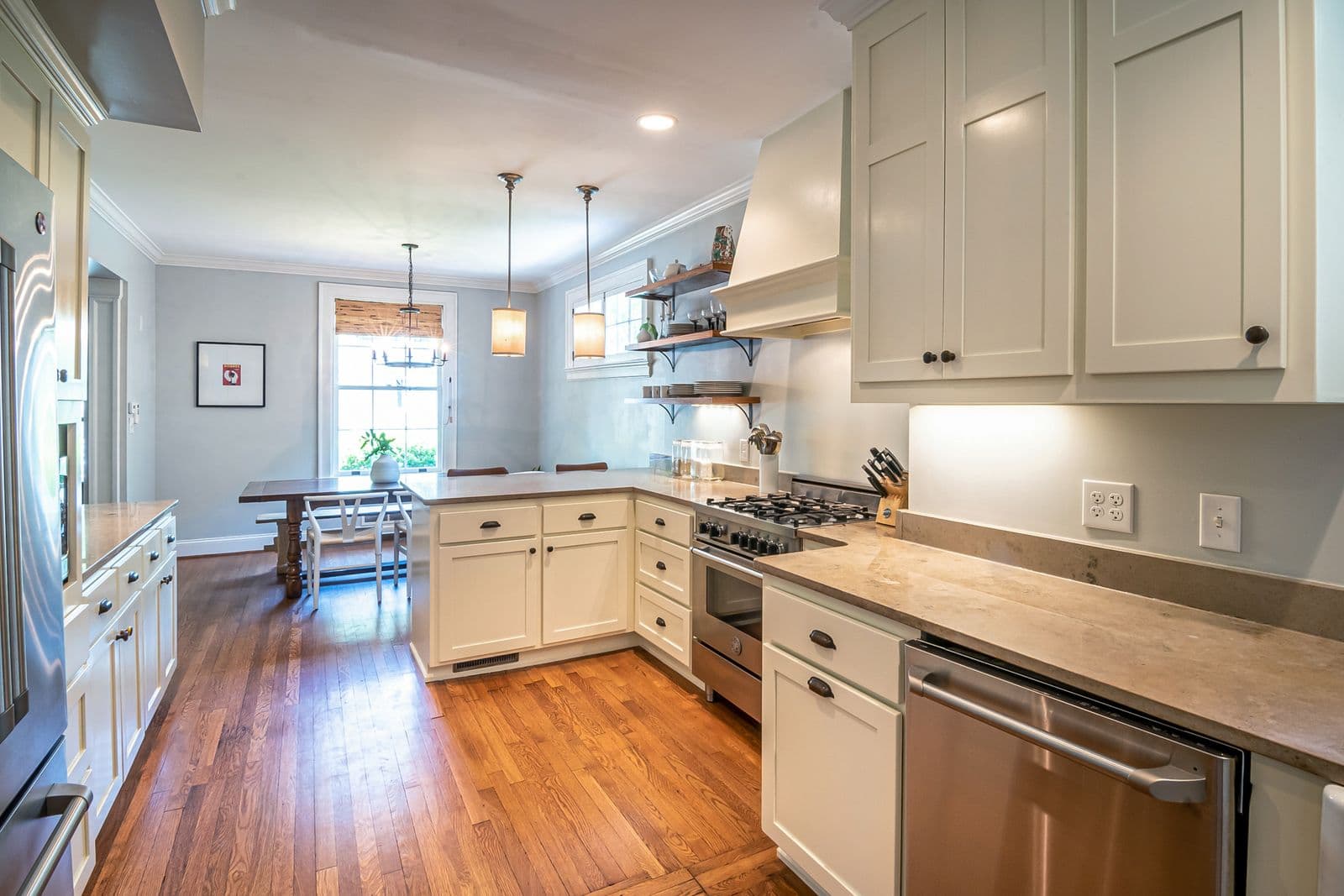 Warm family kitchen with wooden floor and built-in appliances